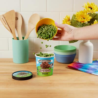 Pint of Chocolate Fudge Brownie being filled with Peas